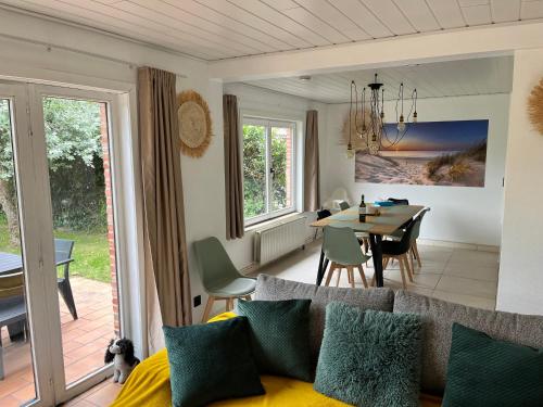 a living room and dining room with a couch and a table at Beach Bungalow Green in Middelkerke