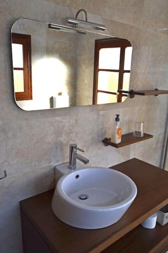 a bathroom with a white sink and a mirror at Casa Manuela LLanes Asturias. in Pendueles