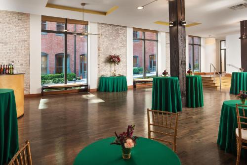 a banquet hall with green tables and chairs at The Westin St. Louis in Saint Louis