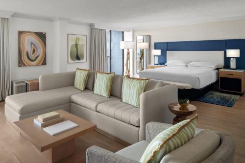 a living room with a couch and a bed at Sheraton Sand Key Resort in Clearwater Beach