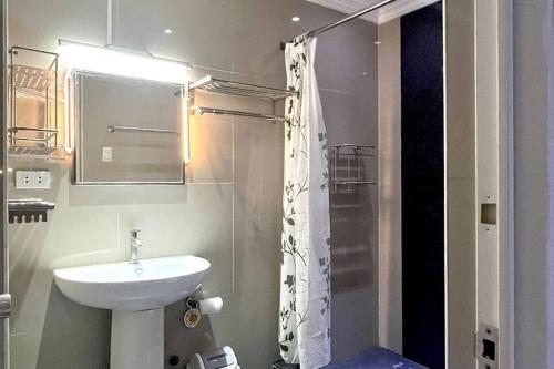 a bathroom with a sink and a shower at Sheryll Updates - Kandi T2 breezy 1BR on 9th floor with Housekeeping & Netflix in Angeles
