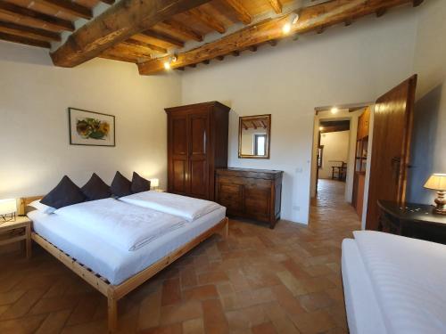 a bedroom with a large white bed and a desk at Villa Lisabetta in Montecchio