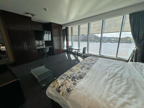 a bedroom with a bed with a view of the water at Rafayel Hotel & Spa in London
