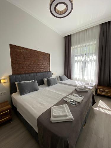 a bedroom with a large bed with towels on it at Galata Moon Hotel in Istanbul