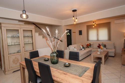 a living room with a table and a couch at John & Angelo Villa in Akrotiri
