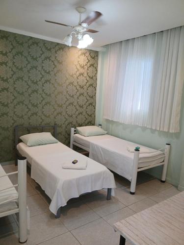 Una cama o camas en una habitación de Pousada Albergue Kafundó