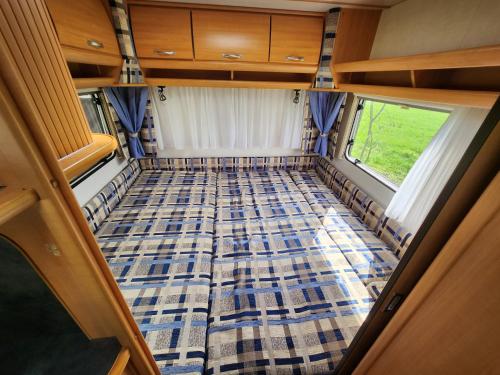 a view from the rear of a camper van with a checkered floor at Ruime caravan op gezellige minicamping in Lichtenvoorde