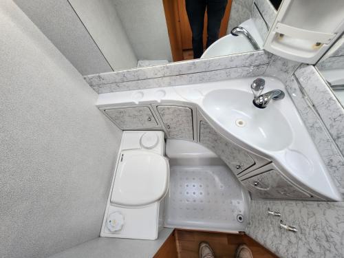 a bathroom with a sink and a toilet at Ruime caravan op gezellige minicamping in Lichtenvoorde