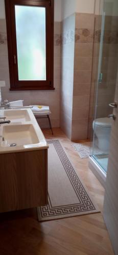 a bathroom with a sink and a shower at Olivo Bonsai in Passignano sul Trasimeno