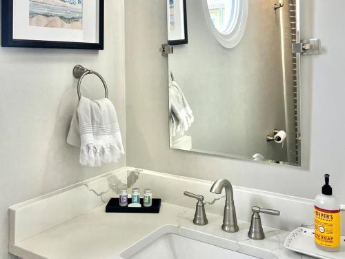 a bathroom with a sink and a mirror at Beach Star Villa in North Topsail Beach