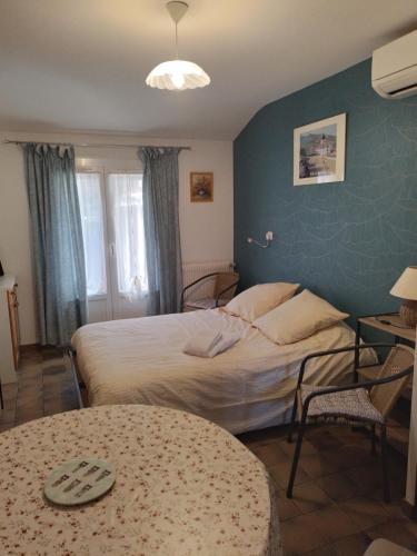 a hotel room with two beds and a table at Studio entre montagne et mer in Cambo-les-Bains