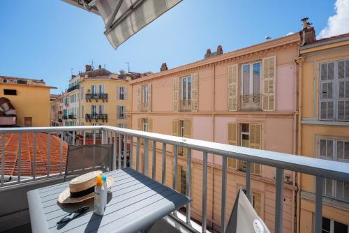 a balcony with a table with a cake on it at Ibis Styles Menton Centre in Menton