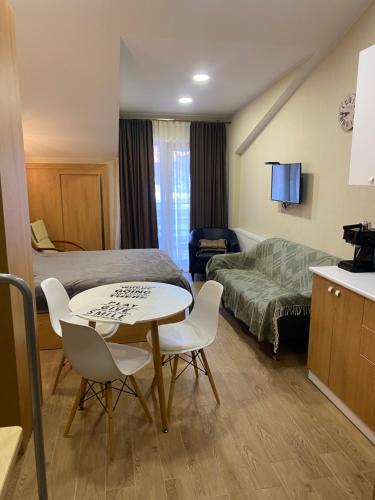 a hotel room with a bed and a table and chairs at Bakuriani inn Apartment in Bakuriani