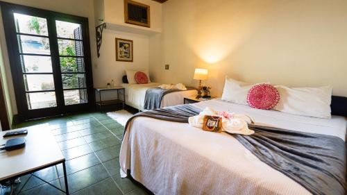 a hotel room with two beds with towels on them at Canto das Laranjeiras Beach Club Guaiuba in Guarujá