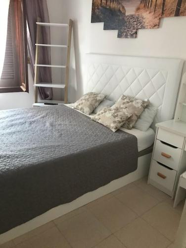 a bedroom with a bed with a white headboard at Chalet de la playa in Oropesa del Mar