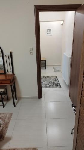 a room with a hallway with a door and a floor with white tiles at Meteora countryside villa in Kalabaka