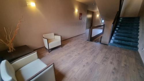 an overhead view of a room with a staircase and a chair at Hotel Villa Delle Rose - Malpensa in Oleggio