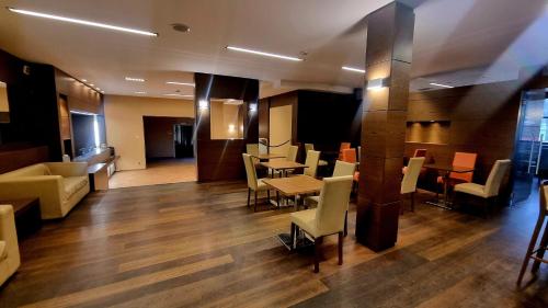 a restaurant with tables and chairs in a building at Hotel Villa Delle Rose - Malpensa in Oleggio