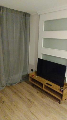 uma sala de estar com uma televisão de ecrã plano sobre uma mesa em Apartamento La Florida Mirador Oriente em Santiago
