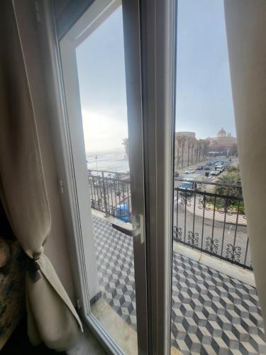 a sliding glass door with a view of a street at Romantic House spettacolare vista mare unica nel suo genere in Alghero