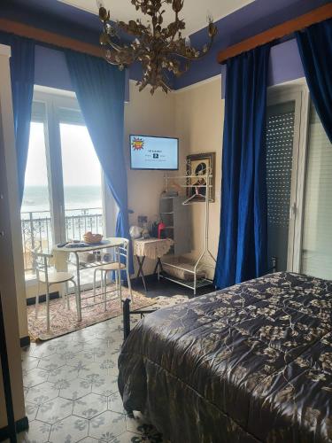 a bedroom with a bed and a view of the ocean at Romantic House spettacolare vista mare unica nel suo genere in Alghero