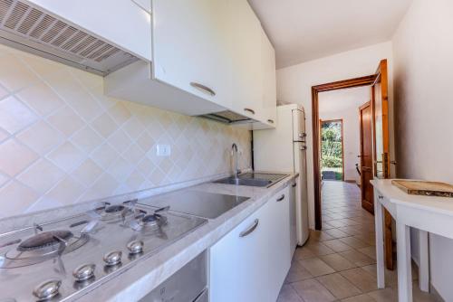 a kitchen with a sink and a refrigerator at Villetta Bagnaia - Goelba in Bagnaia