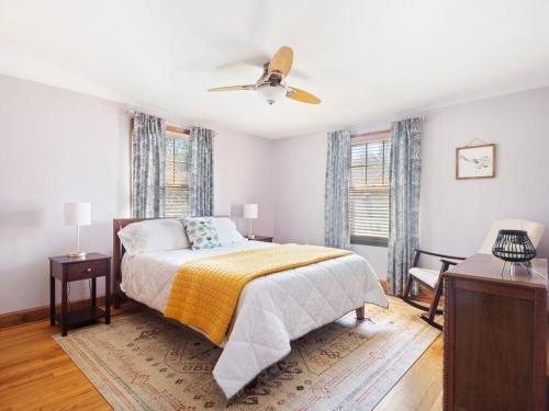 a bedroom with a bed and a ceiling fan at The cottage by the lake in Lakewood