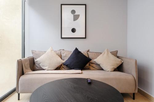 a living room with a couch and a table at Lamartine 205 by Wynwood House in Mexico City