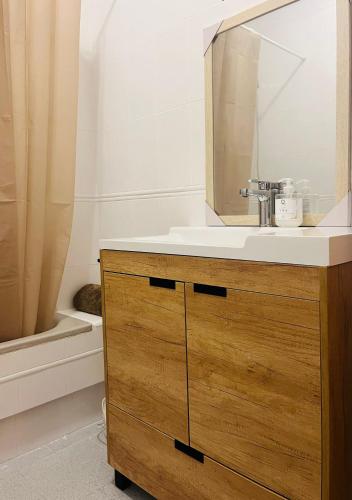 a bathroom with a sink and a mirror and a tub at Casa Almonte in Almonte