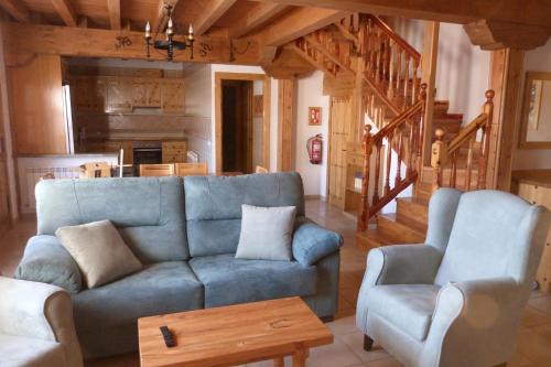 a living room with a blue couch and a table at El Farolillo de Piedra in Montejo de Tiermes
