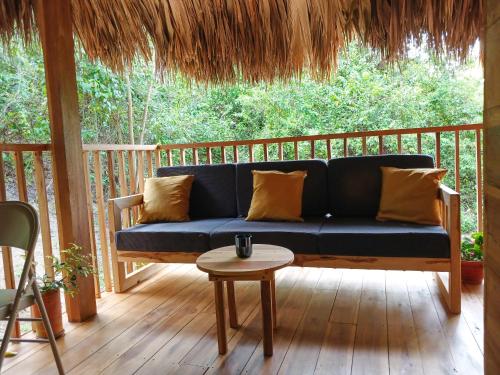 a blue couch on a porch with a table at Casa Sol Y Sombra in Santa Marta