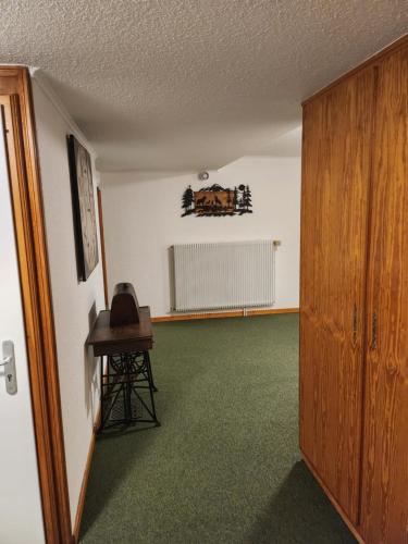 an empty room with a table and a chair in it at Hôtel Au Vieux Moulin in Lapoutroie