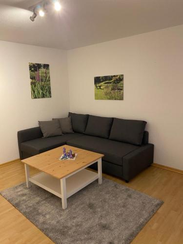 a living room with a couch and a coffee table at Ferienhof Kröger in Bielefeld