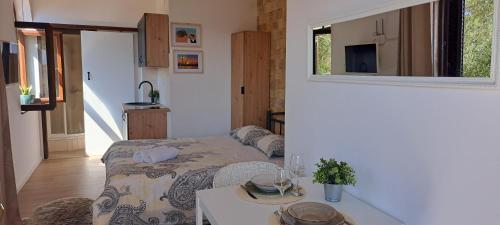 a small room with a bed and a table in it at Studio apartment with sea view in Sali