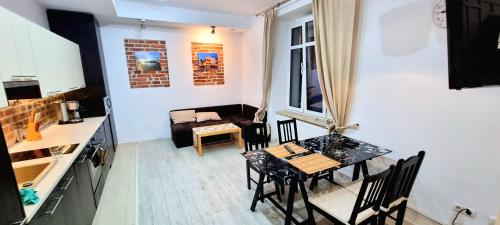 a kitchen and dining room with a table and chairs at Old town brick apartment in Krakow