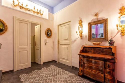 a room with a wooden dresser and a mirror at Romantic House spettacolare vista mare unica nel suo genere in Alghero