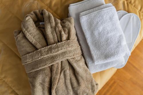 a pair of gloves sitting on top of a bed at Fox studio apartment in Šiauliai