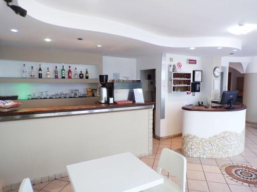 a bar in a restaurant with a white counter at Hotel Frida in Rimini