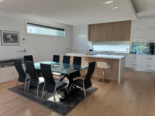 a kitchen with a dining room table and chairs at Geelong Luxury Beach K Villa in North Shore