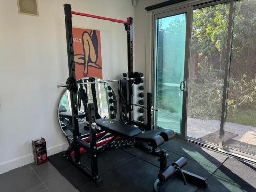 a gym with a bench and a window at Geelong Beach Q House in North Shore