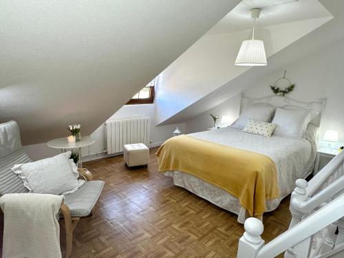 a bedroom with a bed with a yellow blanket at "LAS CAMELIAS SOMO" un lugar para desconectar!! Vistas al MAR!! in Somo