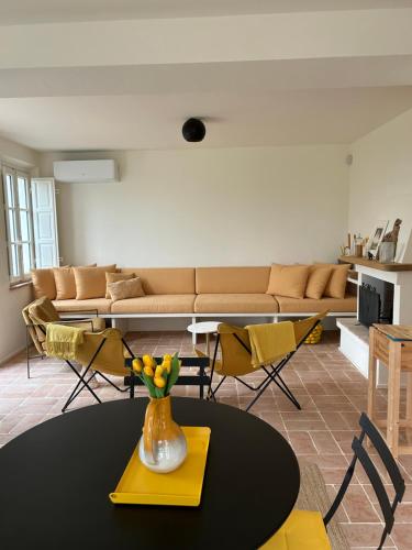 a living room with a table and a couch at Casa Oro in Montecarlo