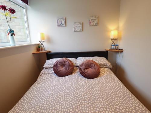 a bedroom with a bed with two pillows on it at Seaside Retreat in Skegness