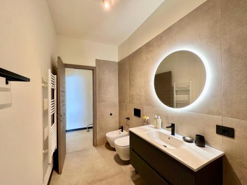 a bathroom with a sink and a toilet and a mirror at Cinque Terre Room Rental SULLA VIA in La Spezia