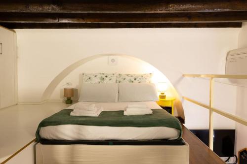 a bedroom with a large bed with an arched ceiling at LaFilo Apartment 1 in Milan