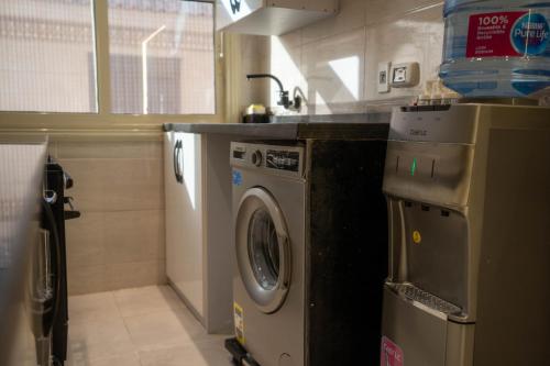 a kitchen with a washing machine and a sink at New Cairo Airport Studio in Cairo