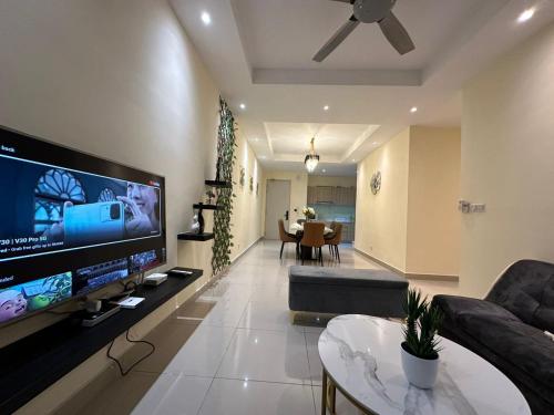 a living room with a large flat screen tv at Meridin Bayvue 3 Bedroom in Kampong Kuala Masai