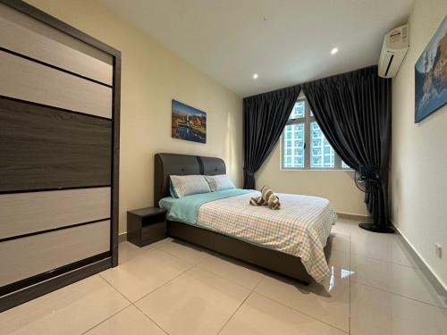 a bedroom with a bed and a large window at Meridin Bayvue 3 Bedroom in Kampong Kuala Masai