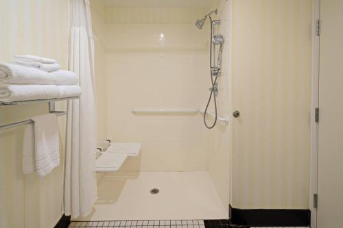 a white bathroom with a shower and a toilet at Fairfield Inn & Suites Seattle Bremerton in Bremerton