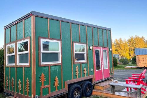 a green and red tiny house sitting on a trailer at Evergreen in Waldport